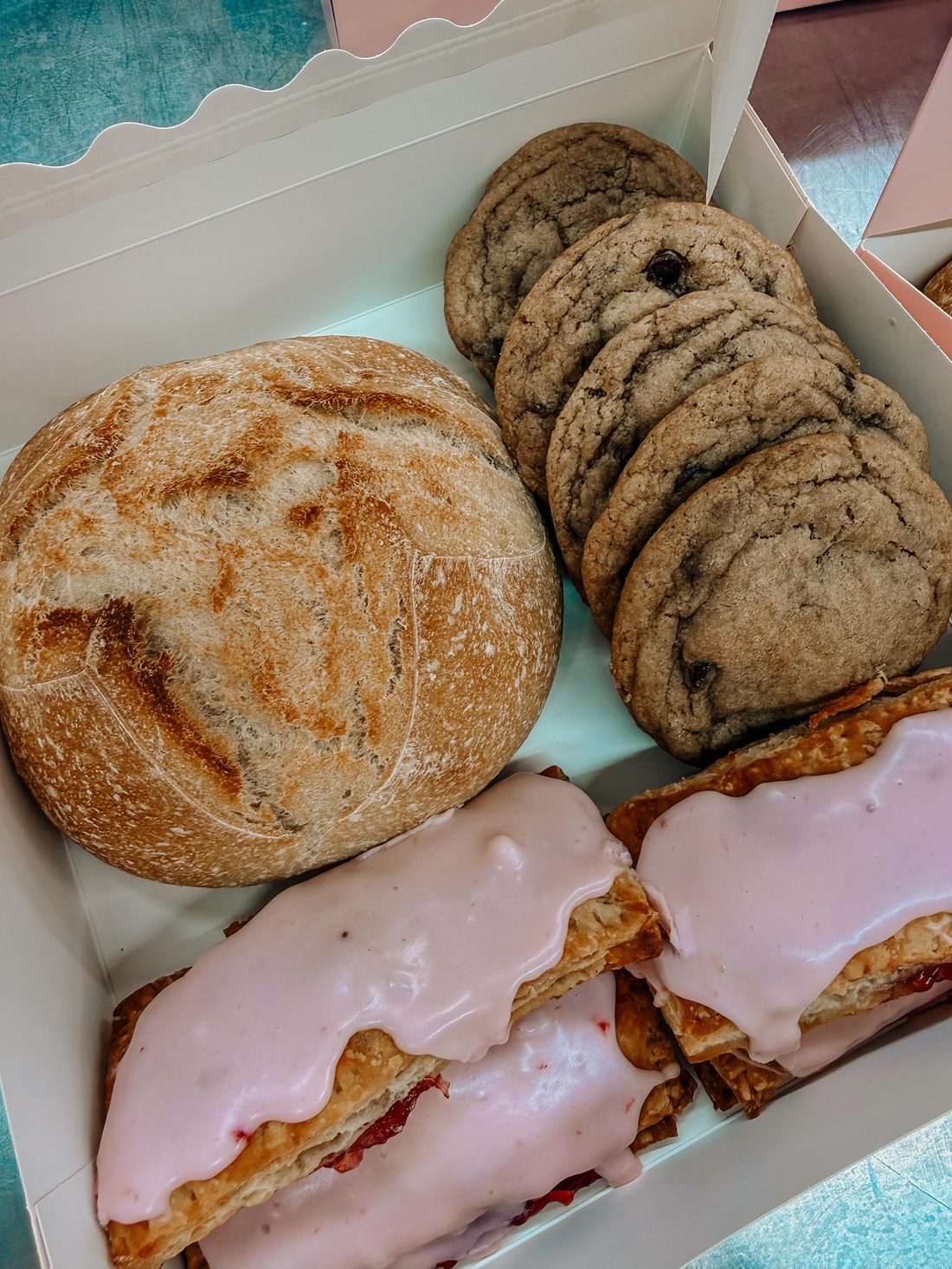 Box of fresh sourdough breads and pastries
